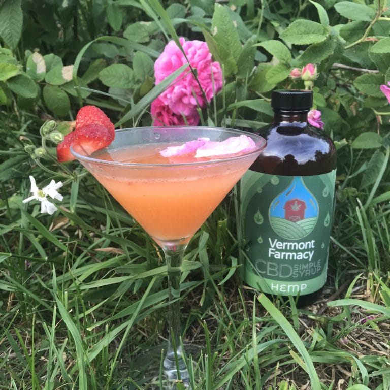 Cocktail made with CBD simple syrup, roses and strawberries